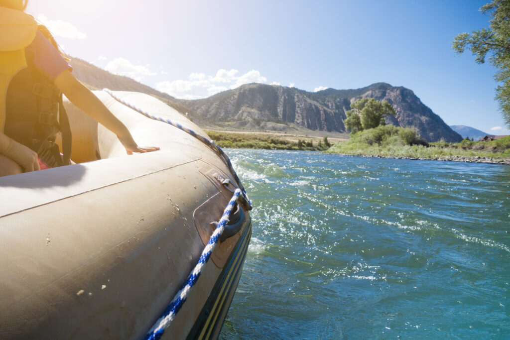 Passengers on Rafting Boat Traveling Down River