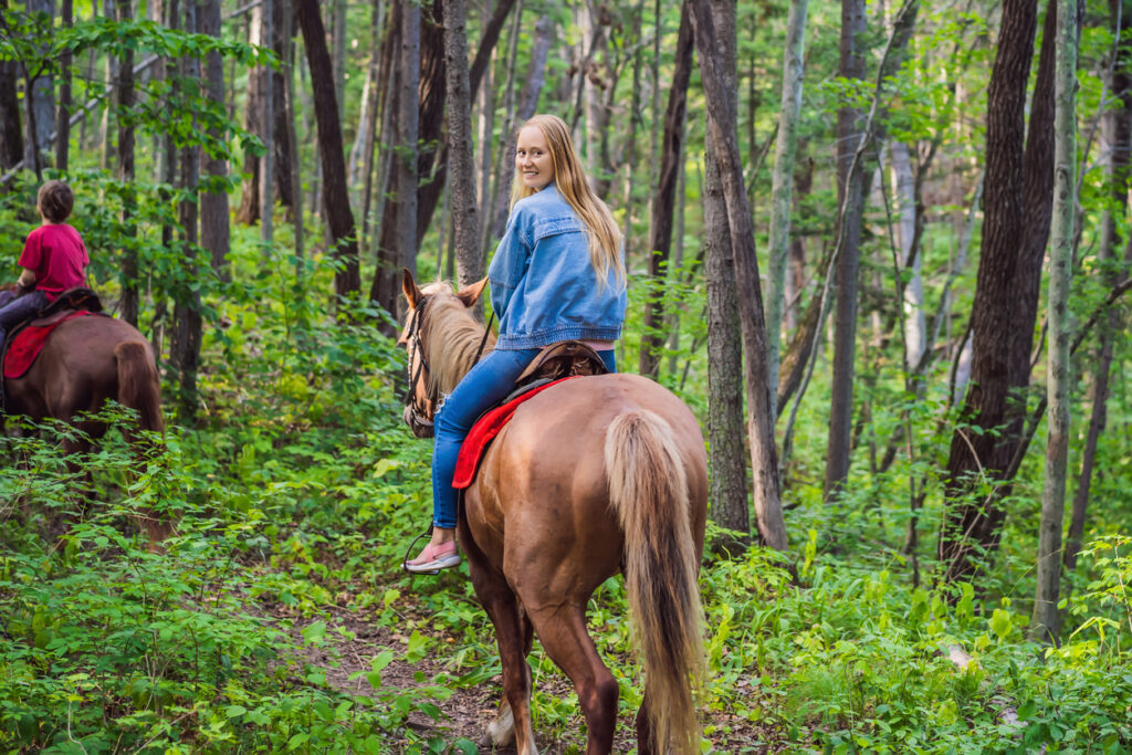 Beautiful woman riding a horse in countryside